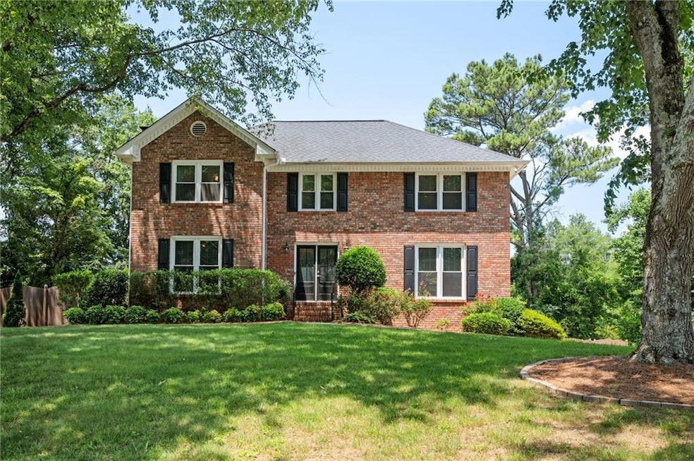 View of front of home with a front yard and brick siding