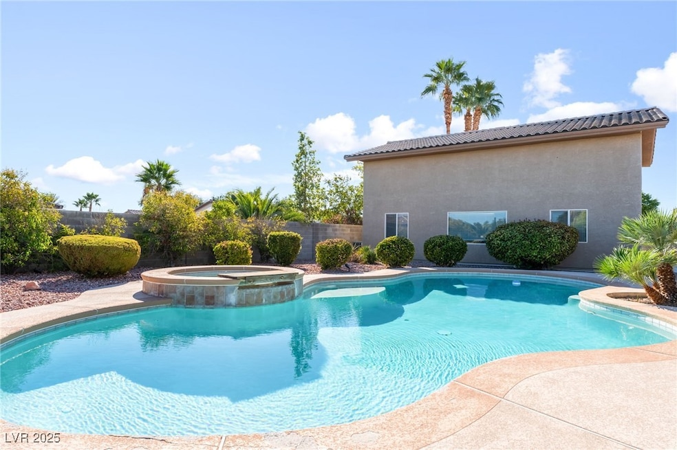 View of swimming pool with a pool with connected hot tub and a patio