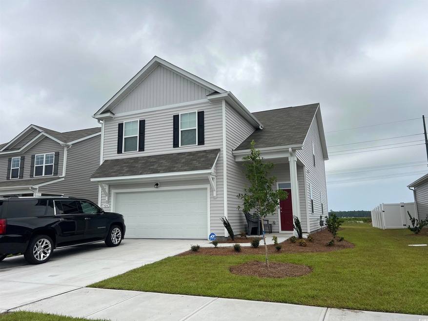 Front facade with a garage and a front yard