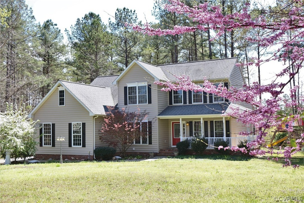 FRONT ELEVATION, PAVED DRIVEWAY, SIDE-LOAD GARAGE, WRAP AROUND PORCH