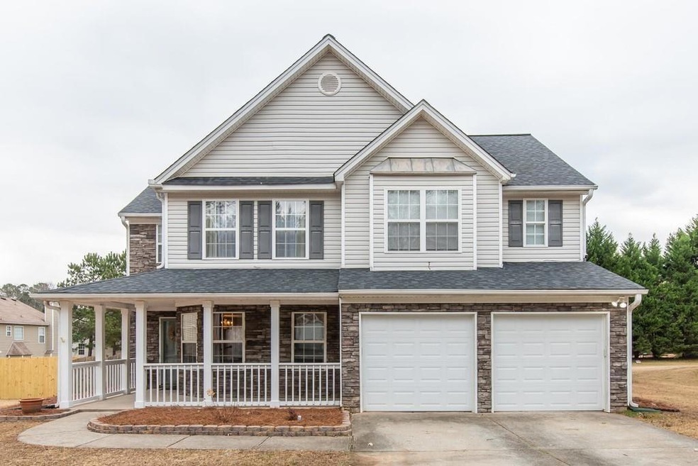 View of front facade with a porch and a garage