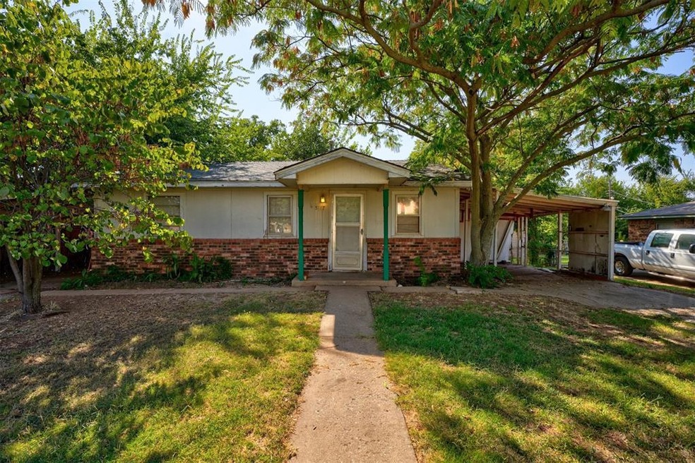 Ranch-style home featuring a front lawn and a carp