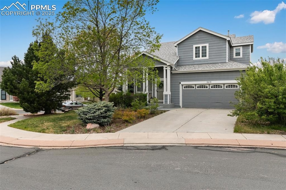 View of front facade with concrete driveway, roof with shingles, and an attached garage