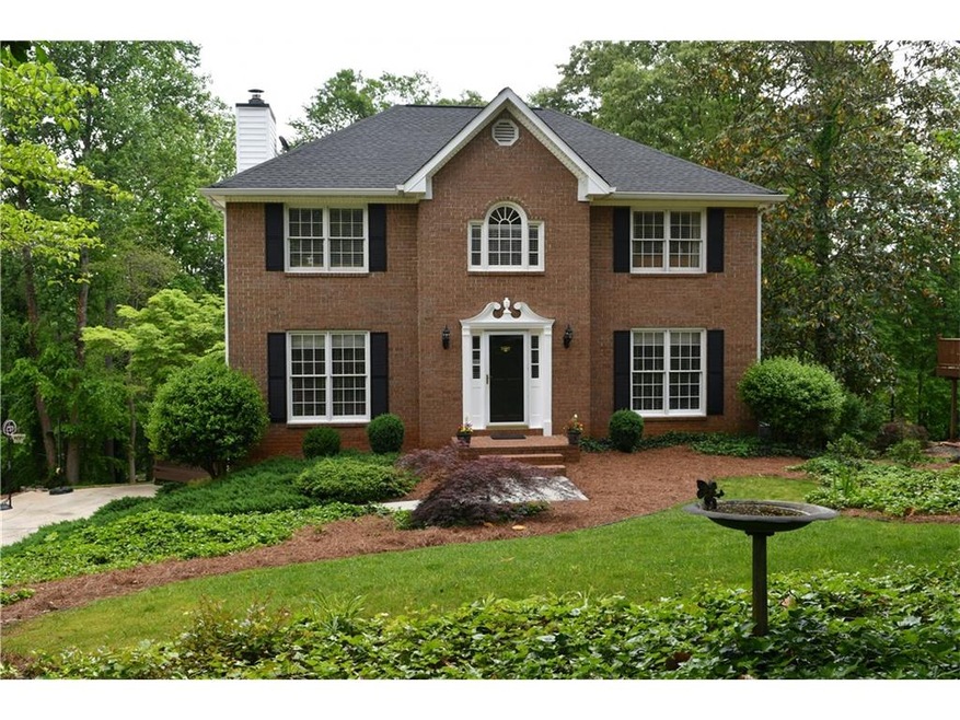 Beautiful brick front home sits on lovely landscap