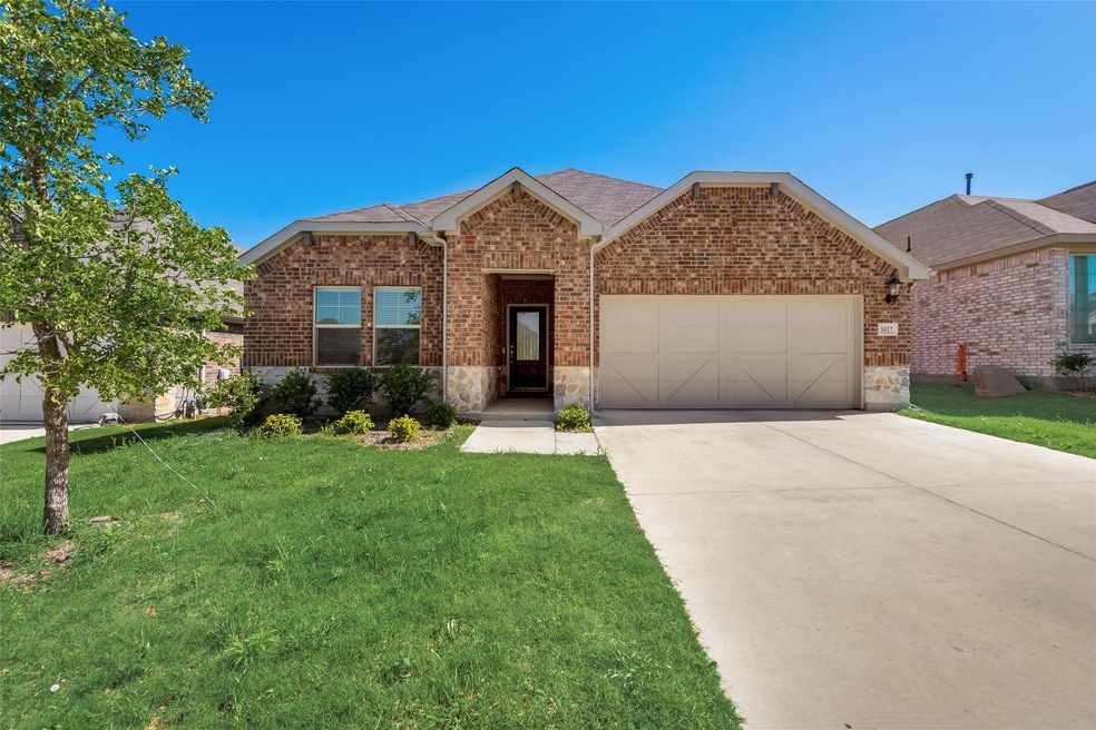 View of front of home with a garage and a front yard