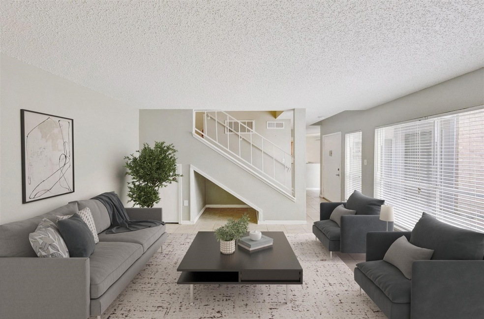 Open living area with corner fireplace and bright