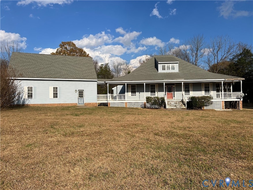 Front of house with a porch, a yard, and a shingled roof