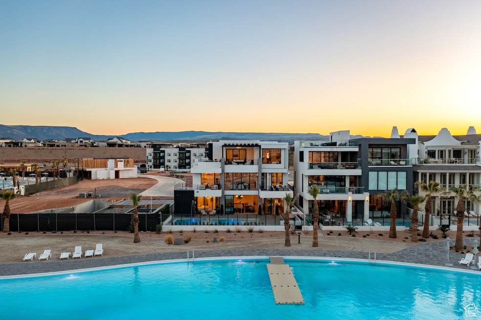 Community pool with fence and a mountain view