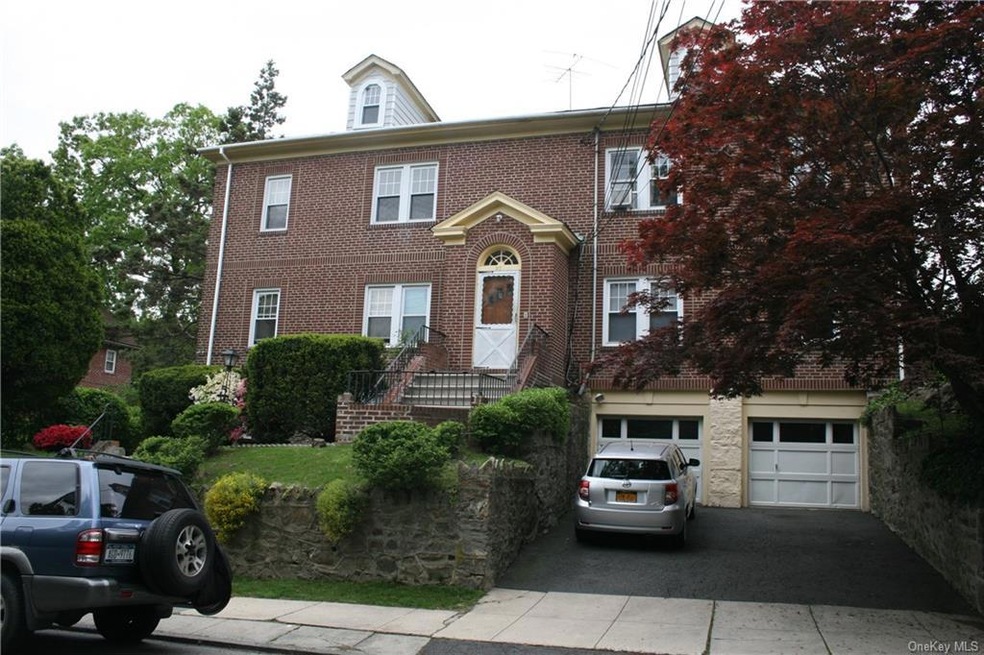 An exterior view of 27 Courter, showing two-car ga