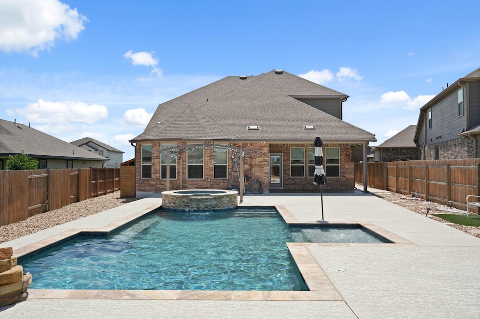 View of pool with a patio, a fenced backyard, and