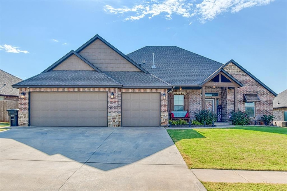 View of front of home with a shingled roof, a front lawn, concrete driveway, and a garage