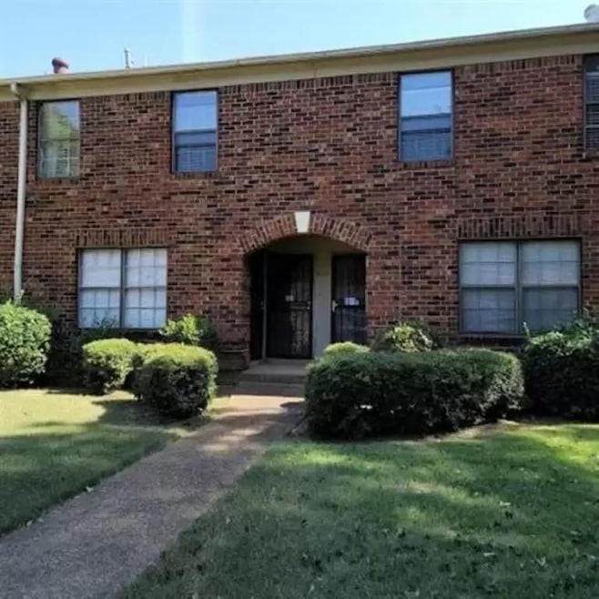 View of property featuring brick siding and a fron