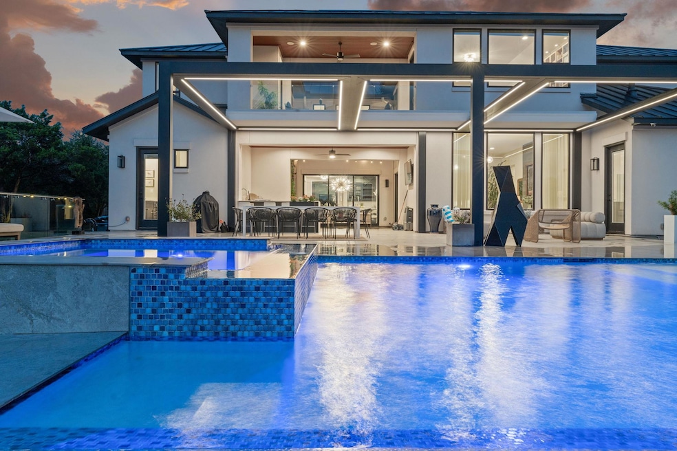 View of pool with an infinity pool, a patio, ceil