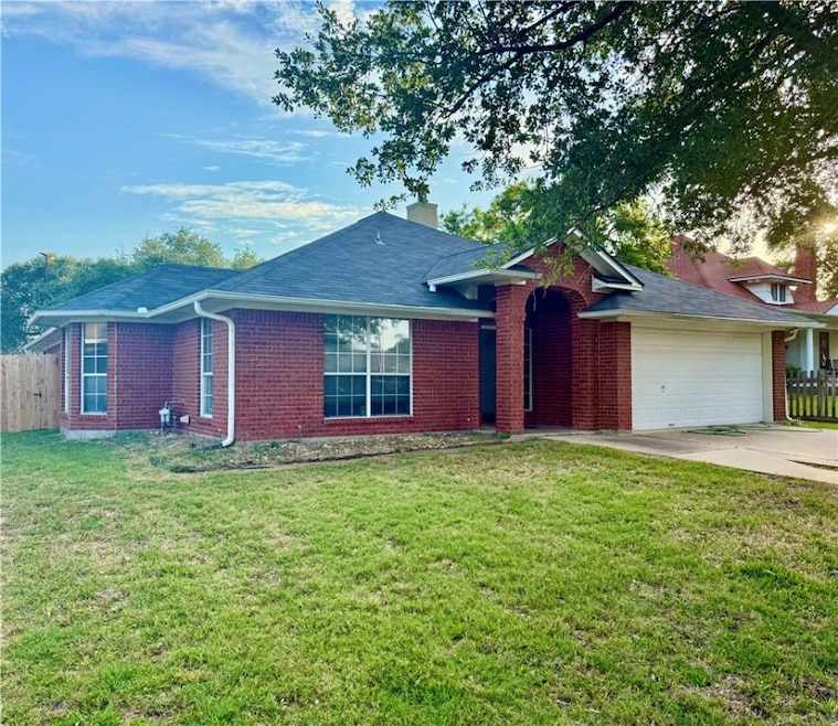Ranch-style home featuring brick siding, a garage,