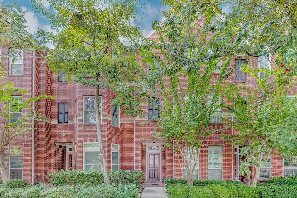 Welcome to 30 Waugh Drive Unit A—nestled under a canopy of mature trees, this red brick traditional townhome makes a charming first impression. The beautifully manicured landscaping and elegant architectural lines set a polished tone from the curb, offering an inviting welcome into this updated, three-story Perry Homes residence in Houston’s sought-after Buffalo Heights neighborhood.
