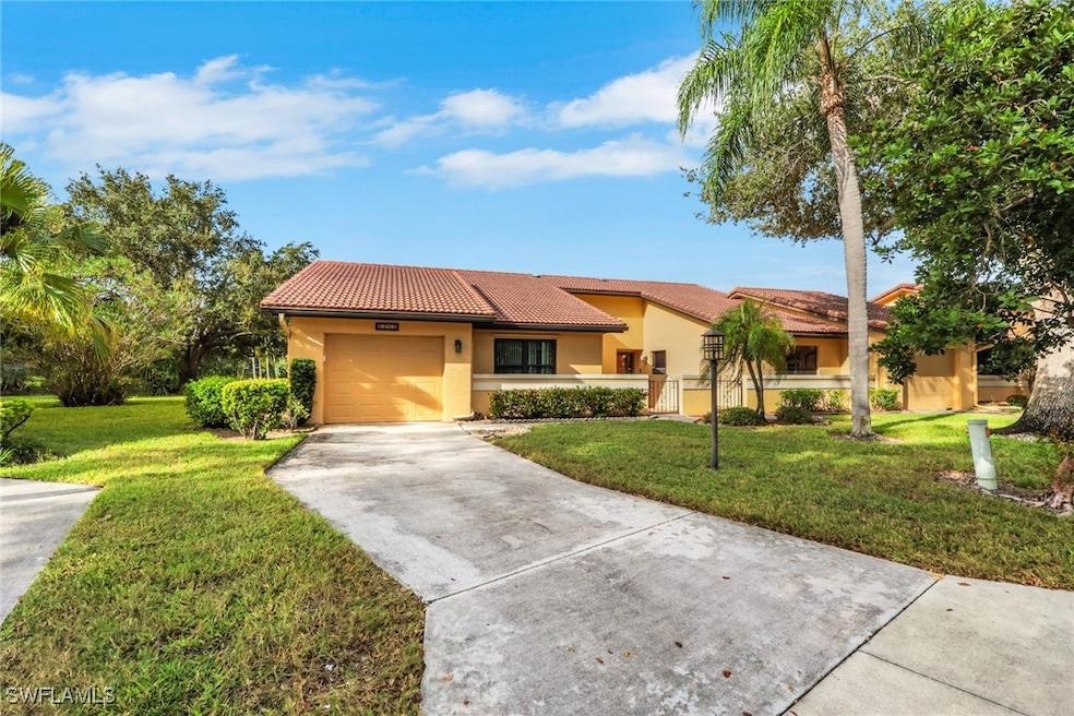 Mediterranean / spanish house featuring a tile roof, concrete driveway, stucco siding, a garage, and a front lawn