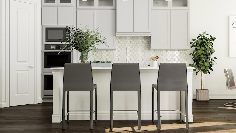 Kitchen with white cabinets, stainless steel oven,