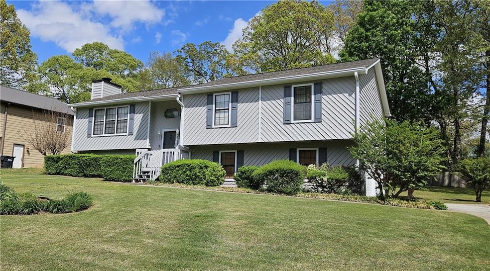 Bi-level home with a front yard and a chimney
