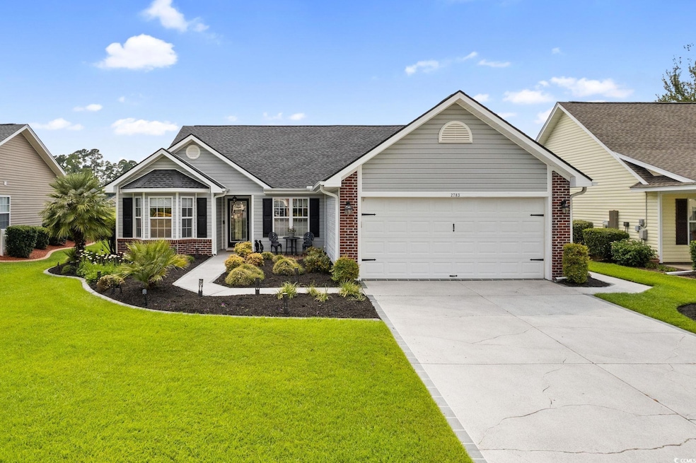 Single story home with brick siding, an attached garage, and a front lawn