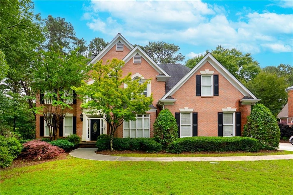 View of front of property featuring brick siding and a front lawn