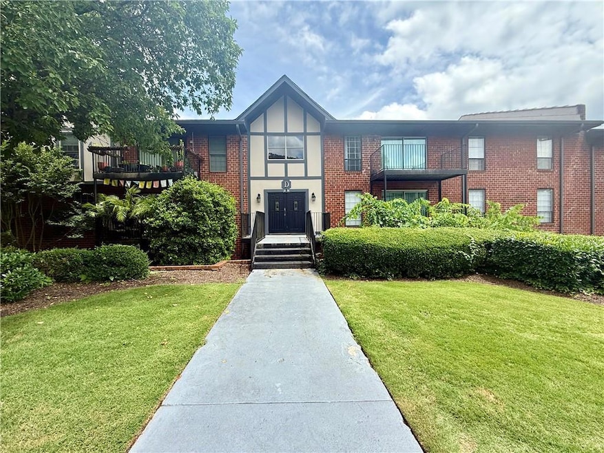 Tudor house with brick siding and a front lawn