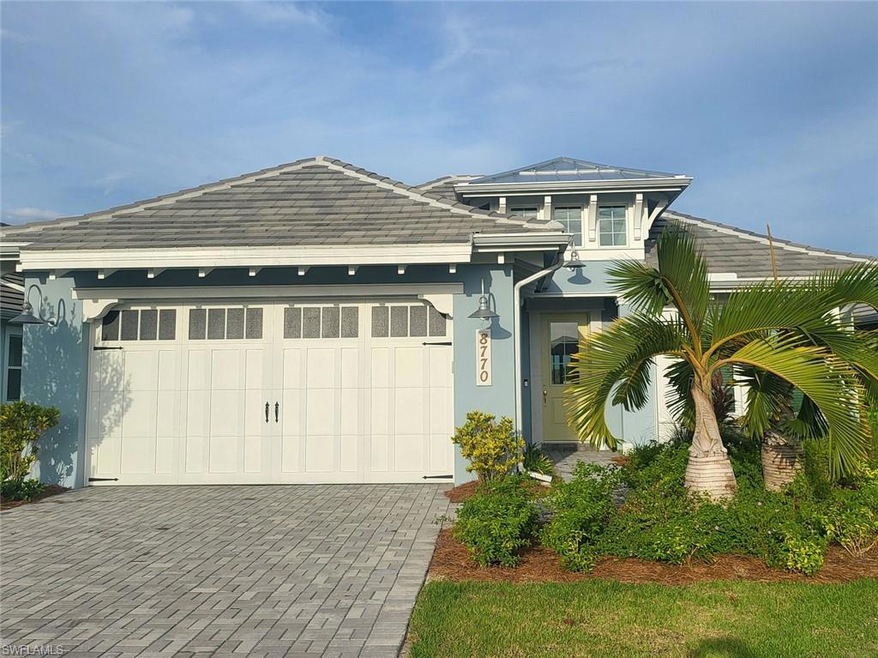 View of front facade featuring stucco siding, an attached garage, and driveway