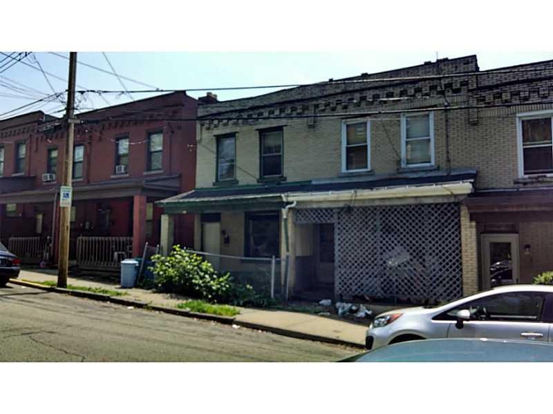 Exterior Front. yellow brick far left