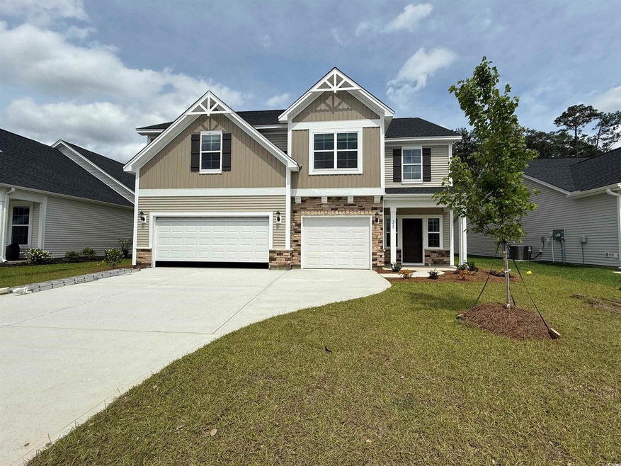 Craftsman-style home featuring stone siding, a garage, driveway, a front lawn, and central air condition unit