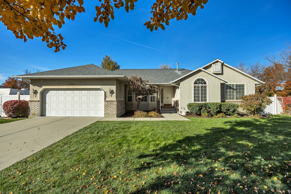 Ranch-style home with brick siding, an attached garage, concrete driveway, stucco siding, and roof with shingles