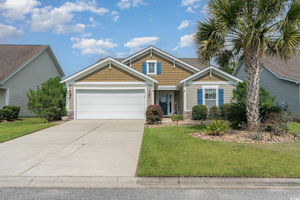 View of front of home with a garage and a front la