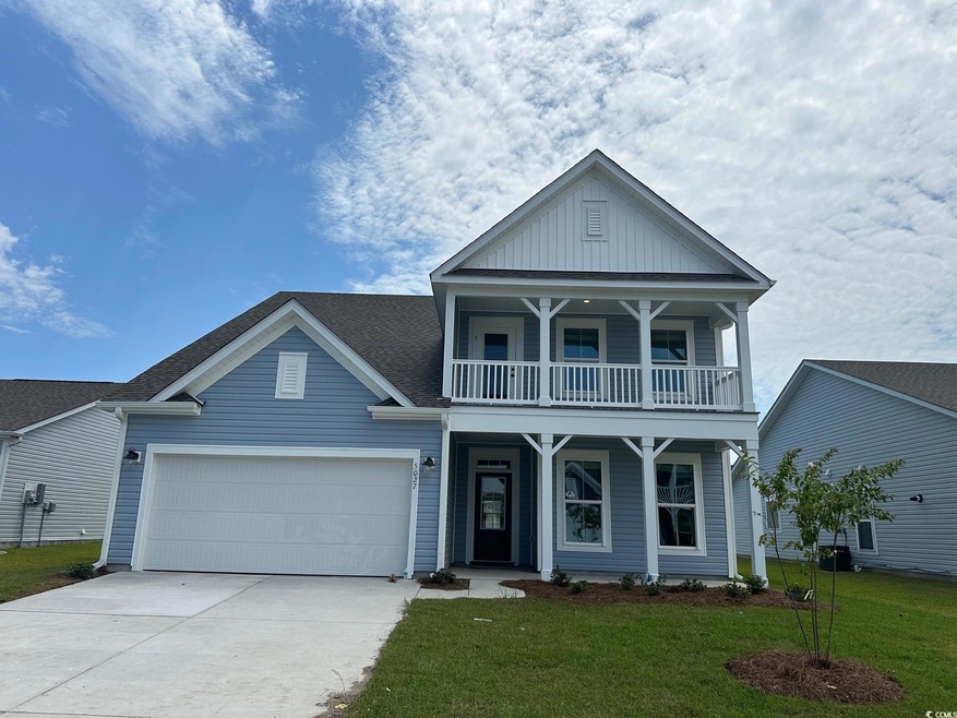 View of front of house featuring a balcony and a f