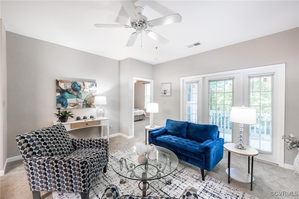 Living room with light carpet and ceiling fan