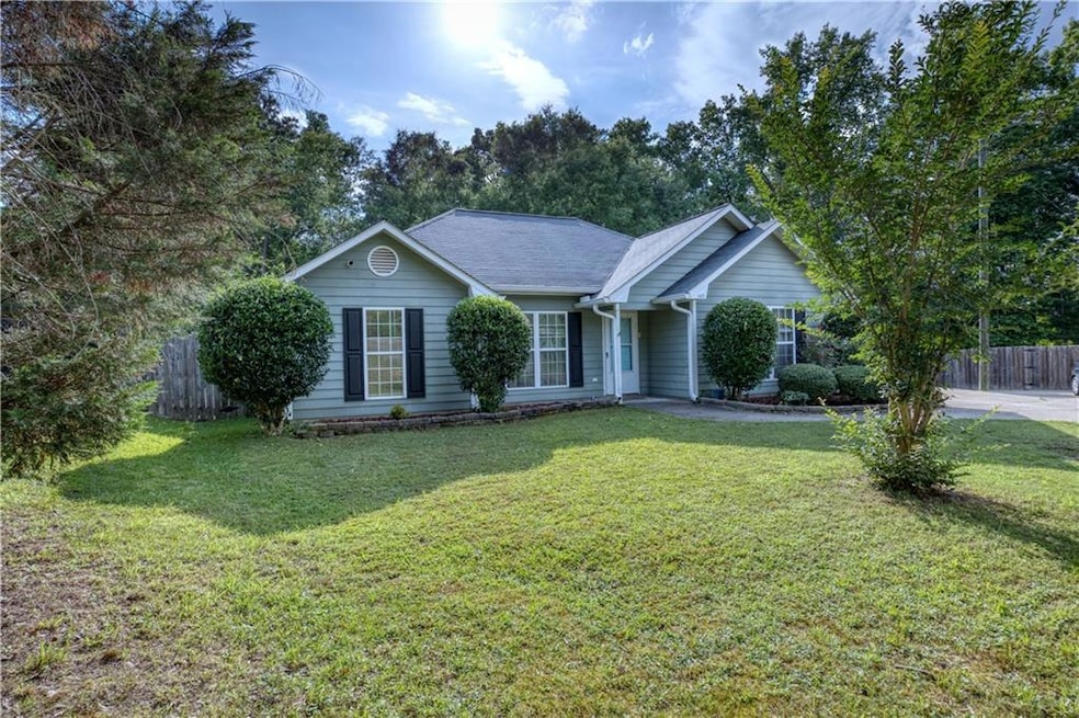 Single story home featuring roof with shingles