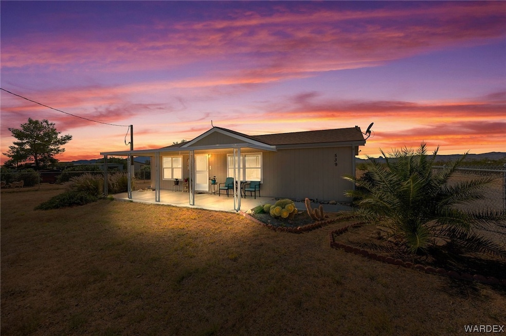 At dusk featuring a patio area
