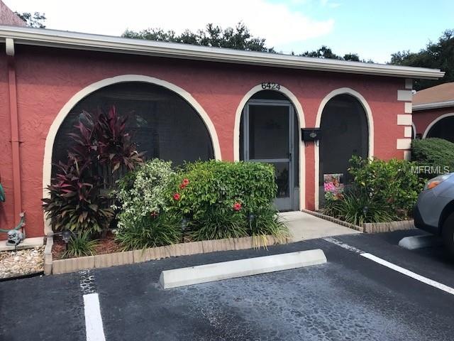 Front of home, screened, tiled front porch, nice f