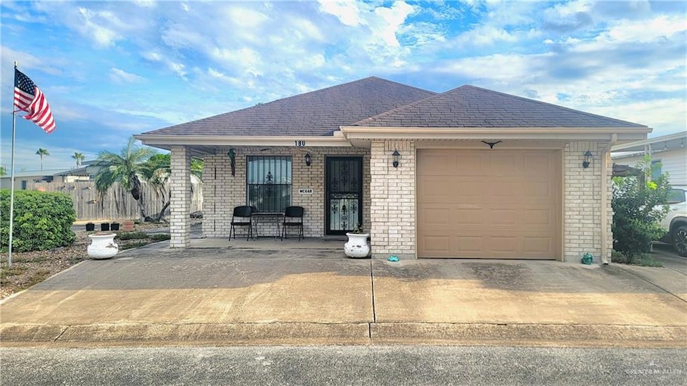 Ranch-style house with an attached garage, brick siding, concrete driveway, a porch, and roof with shingles