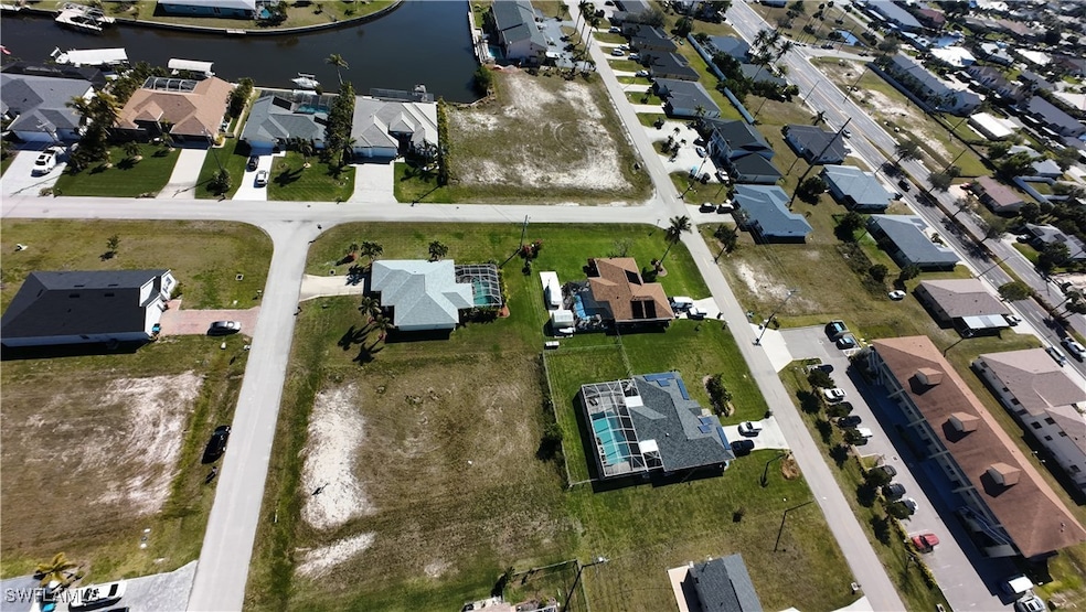 Birds eye view of property with a water view and a