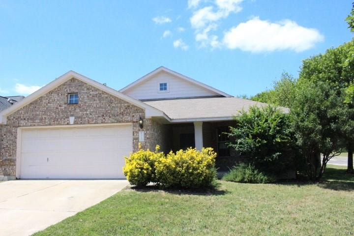 View of front of property with a garage, driveway