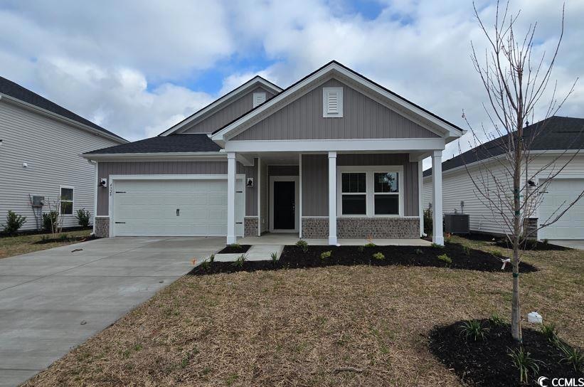 Craftsman house featuring a porch, concrete drivew