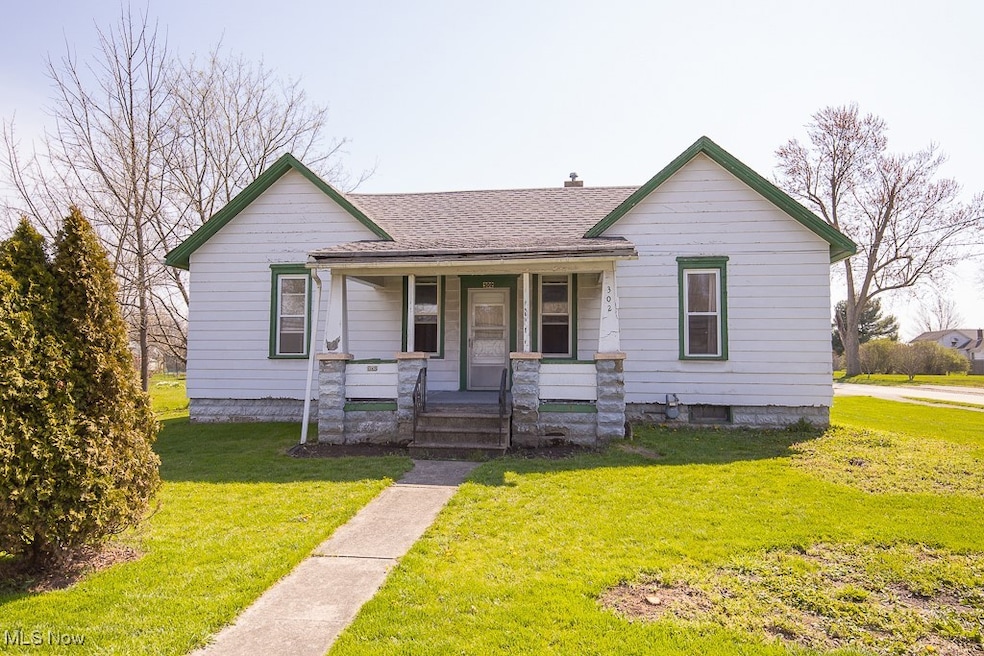 Bungalow with roof with shingles, a front lawn, covered porch, and a chimney