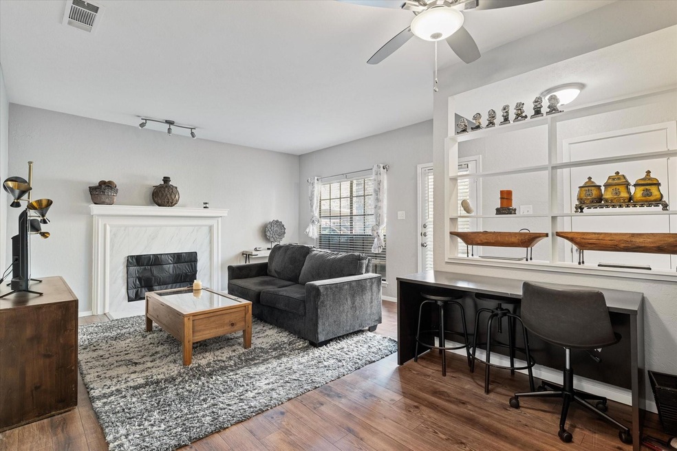 Living room featuring ceiling fan, a premium firep