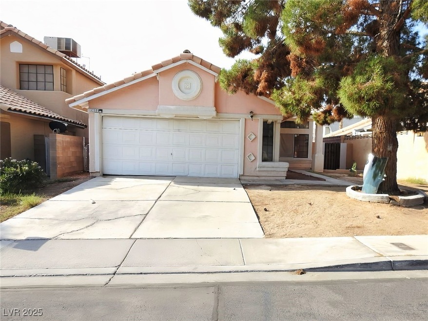 View of front facade featuring driveway, a tiled r