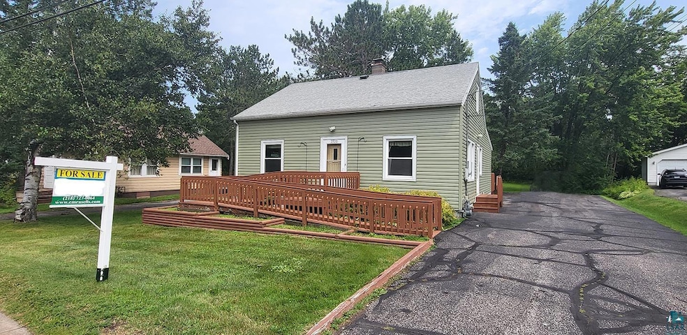View of front facade with a garage, an outbuilding