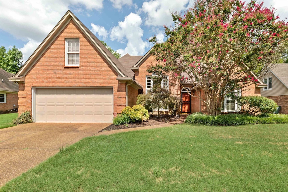 Front facade featuring a garage and a front lawn