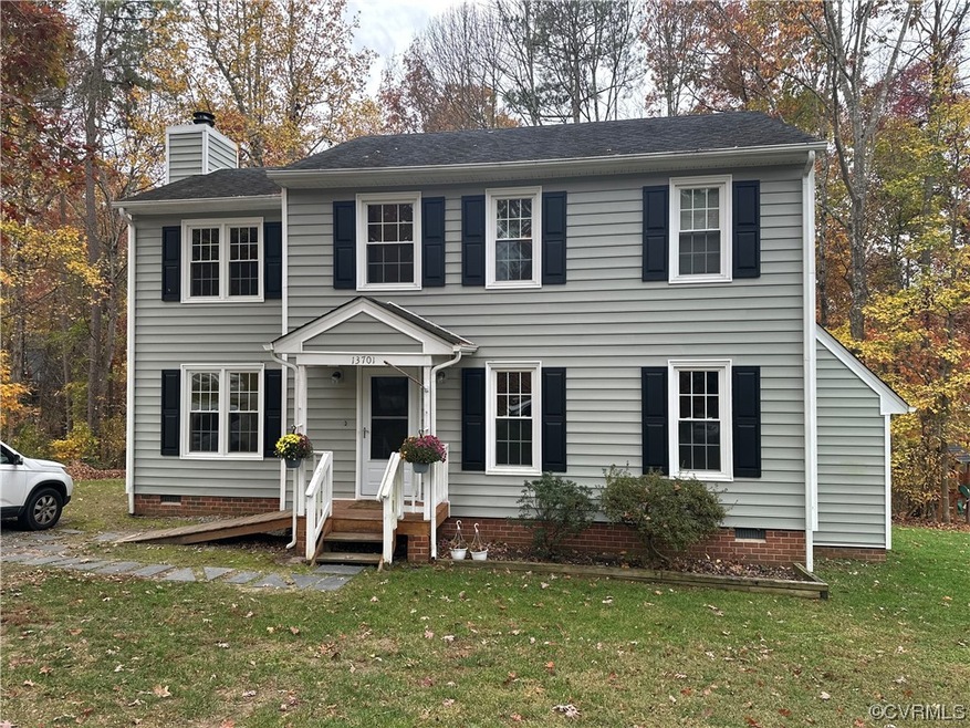 Colonial inspired home featuring a front lawn