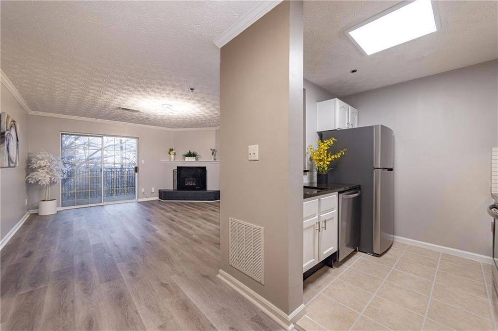 Kitchen featuring white cabinetry, ornamental mold