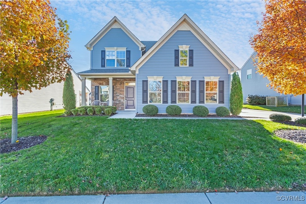 View of front of home with a front lawn and a porc