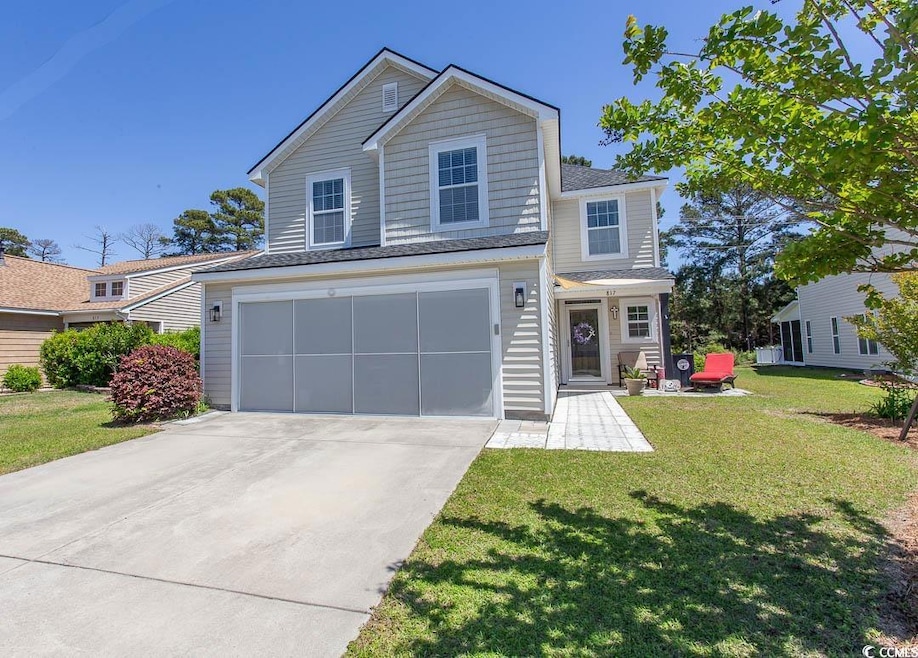 Traditional-style home featuring concrete driveway