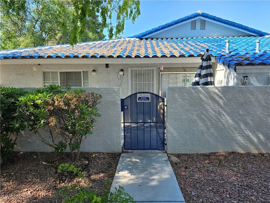 Doorway to property with a gate, stucco siding, an