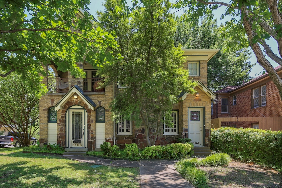 View of front facade with stone siding and a front yard